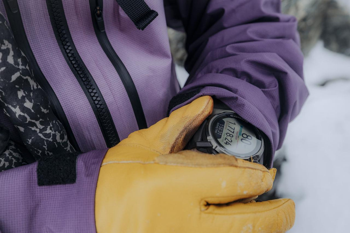 Backcountry ski tourer in the mountains with a COROS watch